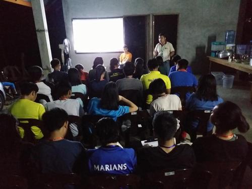 a group of people sitting in front of a screen at Long Titi Homestay in Sematan