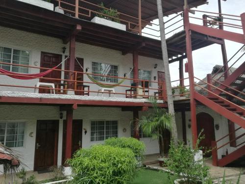 an external view of a building with red stairs at Hotel Gerald in Contadora