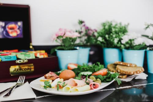 a plate of food with eggs and vegetables on a table at Frangiorgio Hotel in Larnaka