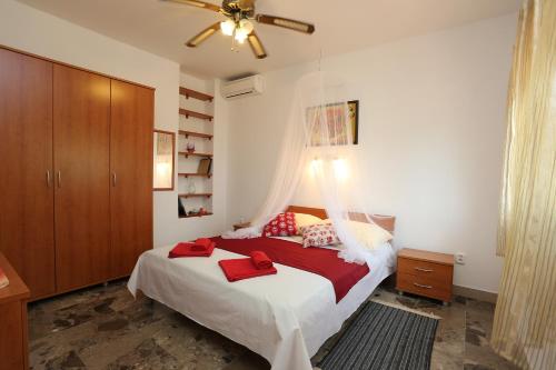 a bedroom with a bed with a ceiling fan at Foltyn Holiday Home in Selca