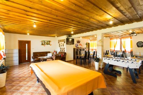 a room with a bed and a ping pong table at Apartmány PACIFIC in Demanovska Dolina