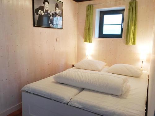 a bed with two pillows on it in a room at Huisje in Stavelot in Stavelot