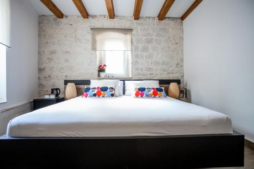 a bedroom with a large white bed with pillows at Villa Lucia in Trogir