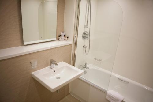 a bathroom with a sink and a shower at Malvina House Hotel in Stanley