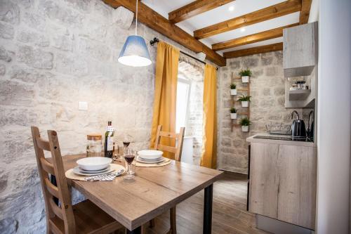 a kitchen and dining room with a wooden table at Villa Lucia in Trogir