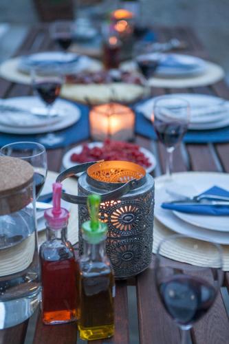 a wooden table with plates and glasses and a candle at Villa Lucia in Trogir