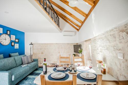 a living room with a blue couch and a table at Villa Lucia in Trogir