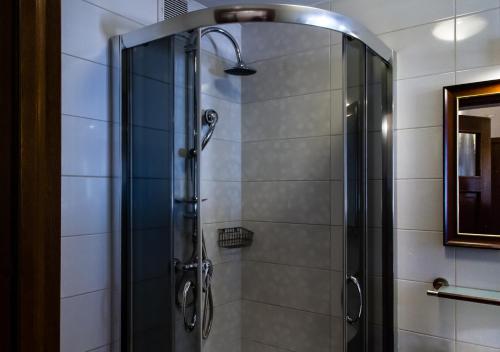 a shower with a glass door in a bathroom at Lublin Apartaments in Lublin