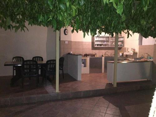 a kitchen with chairs and a table and a counter at Tsanis in Parga