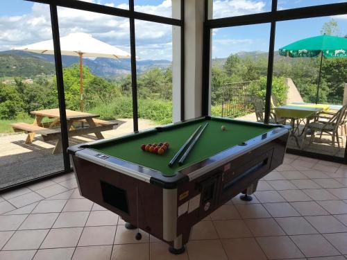 a pool table in a room with a view at Hôtel le Panoramic - Votre Hôtel au cœur des Gorges du Verdon in La Palud sur Verdon