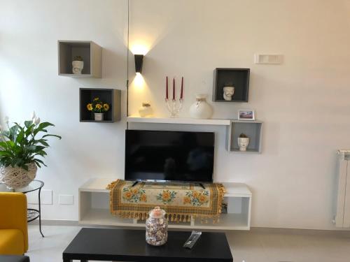a living room with a flat screen tv on a wall at B & B Il Giardino sul Mare in Briatico