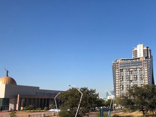 a large building with a mosque and a tall building at Urban Awe Apartment-iTowers 23rd Floor in Gaborone