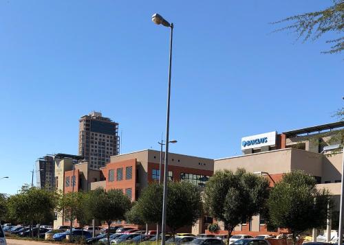 a street light in a parking lot in a city at Urban Awe Apartment-iTowers 23rd Floor in Gaborone
