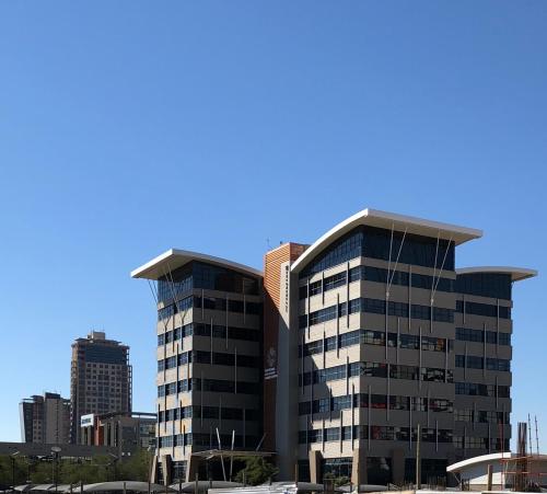a large office building in a city at Urban Awe Apartment-iTowers 23rd Floor in Gaborone