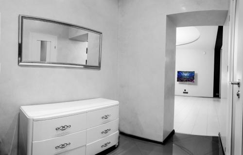 a bathroom with a white dresser and a mirror at Apartment Arkadiya, three bedrooms! in Odesa