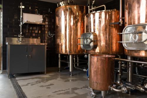 a brewery with two large copper tanks in a room at The Peacock at Barlow in Chesterfield