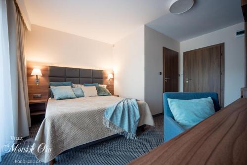 1 dormitorio con 1 cama y 1 silla azul en villa Morskie Oko en Pogorzelica