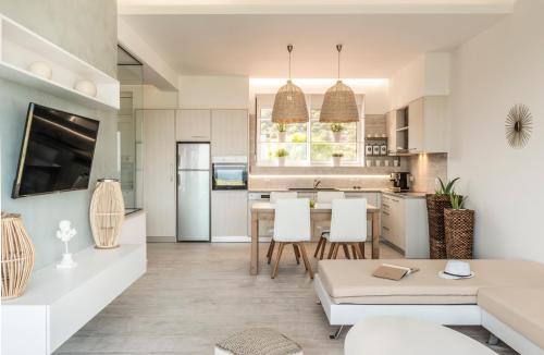 a kitchen and living room with a table and chairs at Kallia Luxury private in Ierapetra