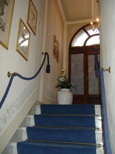 a blue carpeted staircase in a house with a door at Villa Carlotta con piscina in Lari