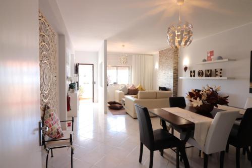 a living room with a table and a couch at APARTAMENTO MICÁ in Albufeira