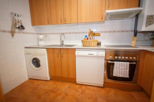 a kitchen with a sink and a washing machine at El Bulín de Piñuecar in Piñuécar