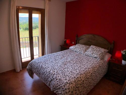 a bedroom with a bed and a large window at El Bulín de Piñuecar in Piñuécar