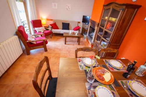 a dining room with a table and chairs and a living room at El Bulín de Piñuecar in Piñuécar