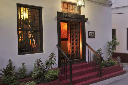 a staircase leading to a room with a fire place at Zanzibar Palace Hotel in Zanzibar City