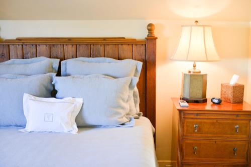 a bed with white pillows and a night stand with a lamp at Terrell House Bed and Breakfast in New Orleans