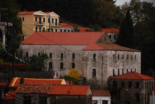 an old stone building with red tile roofs at Villa Aleka in Samothráki