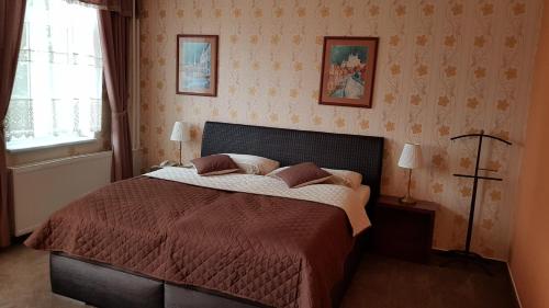 a bedroom with a large bed in a room at Hotel Lipa in Bojnice