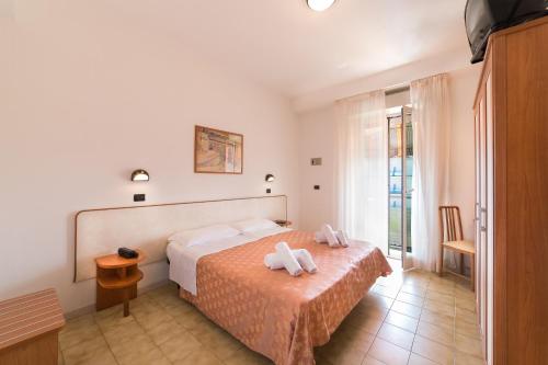 Postel nebo postele na pokoji v ubytování Hotel Garisenda