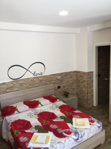a bedroom with a bed with red roses on it at Beb la lupa in Rome