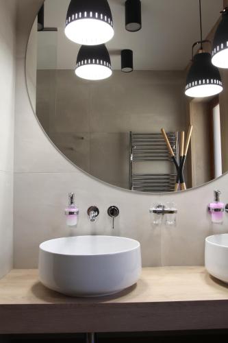 a bathroom with a white sink and a mirror at Apartmán 17 Romantika Chopok Juh Tále in Tale