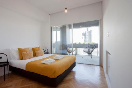 a bedroom with a large bed and a balcony at Liiiving in Porto | Downtown Secret Luxury Apartments in Porto