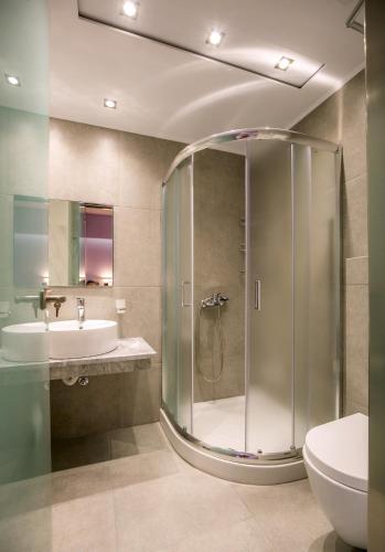 a bathroom with a shower and a sink and a toilet at Villa Dimitris in Potos