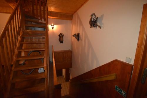 a stairway in a house with a wooden stair case at Horská bouda U Kokrháče in Dolní Malá Úpa