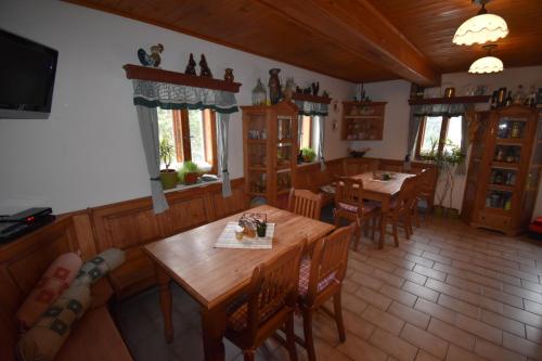 a dining room with wooden tables and chairs at Horská bouda U Kokrháče in Dolní Malá Úpa