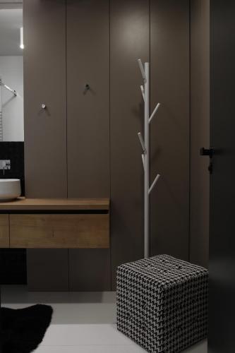 a bathroom with a sink and a counter with a stool at Apartmán 16 Romantika Chopok Juh Tále in Tale