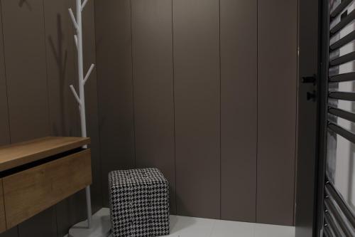 a bathroom with gray walls and a bench and a stool at Apartmán 16 Romantika Chopok Juh Tále in Tale