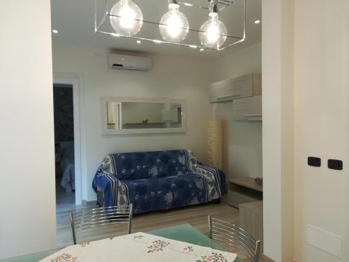 a living room with a blue couch and chairs at Casa Anna in Moneglia