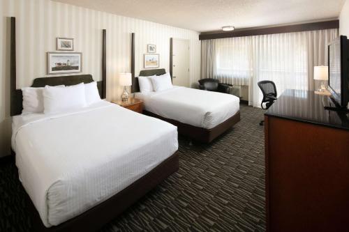 a hotel room with two beds and a television at Red Lion Hotel Bellevue in Bellevue