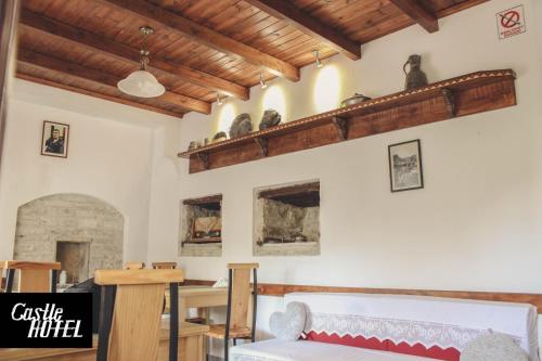 a room with a bed and a shelf on the wall at Castle Hotel in Gjirokastër