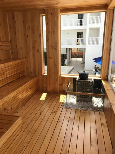 a room with a wooden floor and a large window at Hotel Anapoima in Anapoima