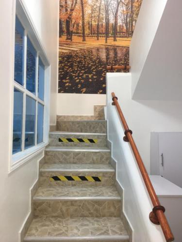 a set of stairs with a painting on the wall at Casa Hotel Manco Mora in Medellín