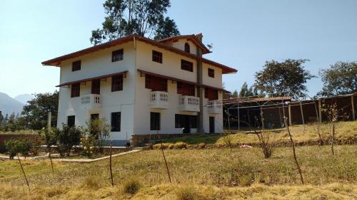 a house on top of a hill in a field at Lodge Acopampa Inn in Carhuaz