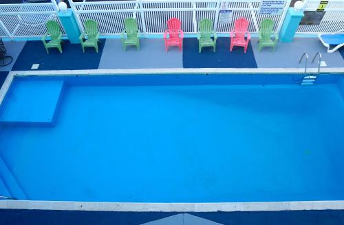 a row of chairs and a swimming pool at Beachside Resort in Wildwood