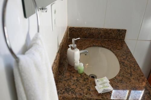 a bathroom with a sink with a soap dispenser at Chale Vista Encantada in Lavras Novas