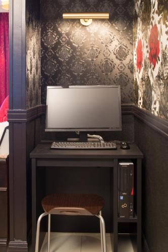 a desk with a computer monitor and a chair at Canon Himeji Higashi (Adult Only) in Himeji