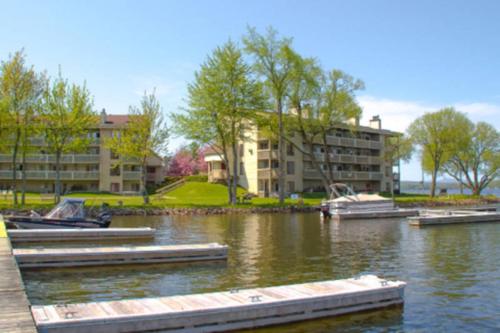 a marina with boats in the water next to a building at Condo de L'Oberge in Magog-Orford